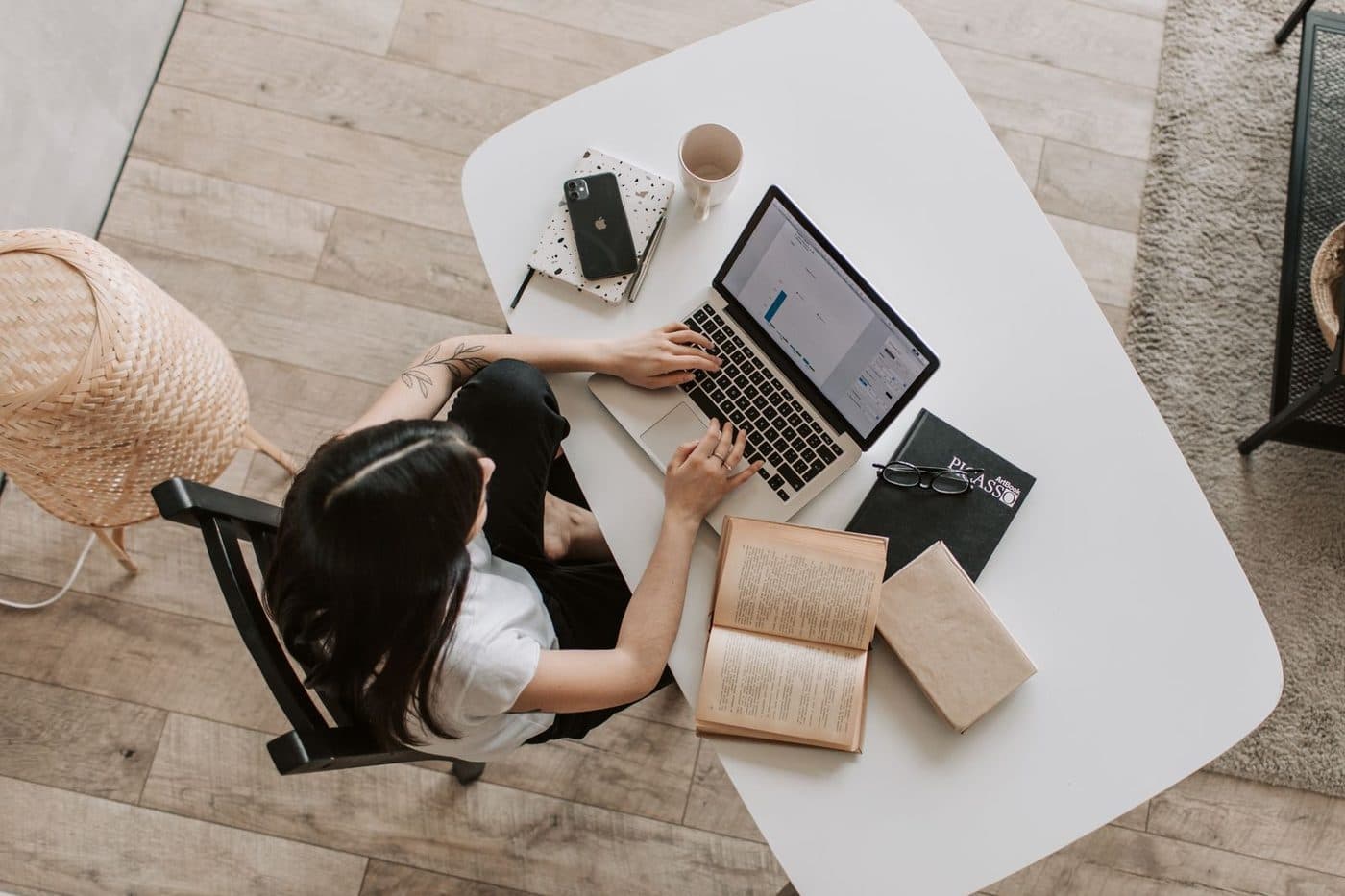 Hunched posture while working on a laptop at a low table