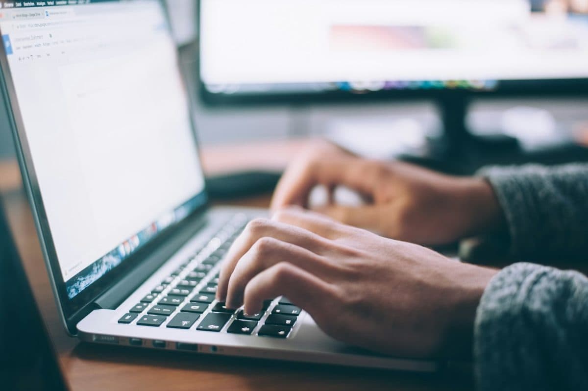 Desk worker sitting at a laptop during a long work session