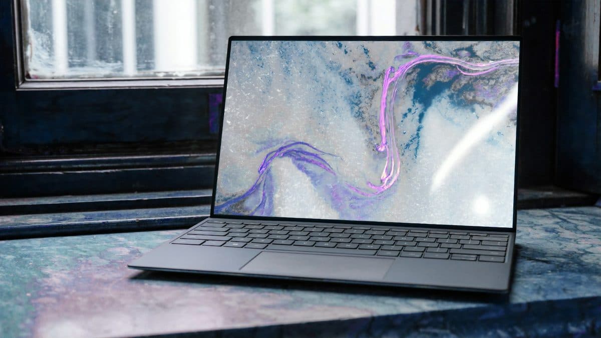 Laptop raised on a stand toward eye level on a clean desk