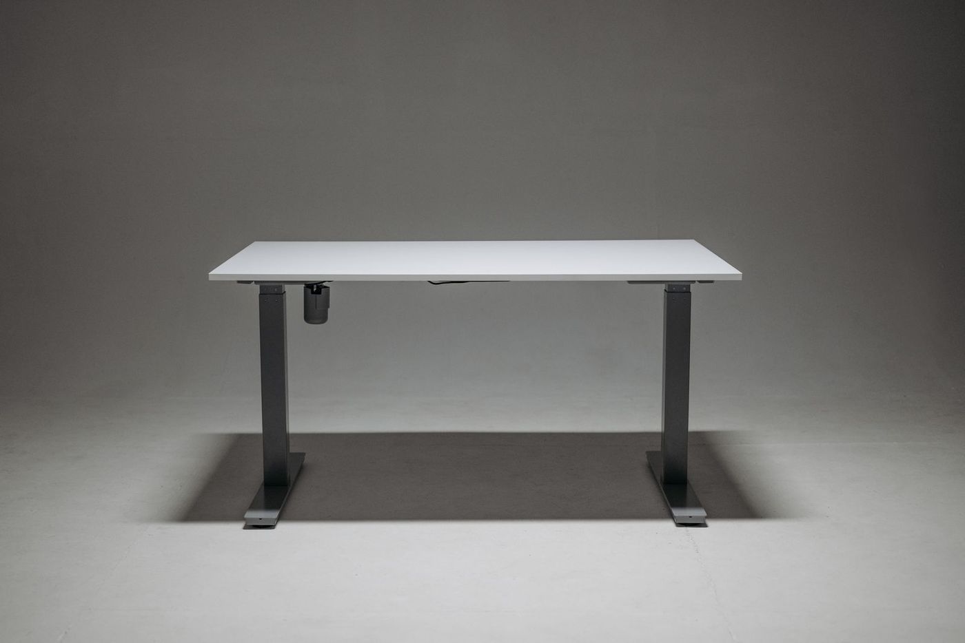 Electric height-adjustable desk frame with a white desktop